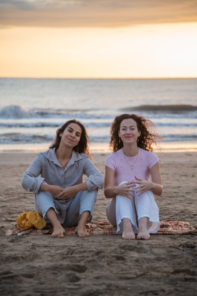 Timeless Reset founders sitting together on the beach